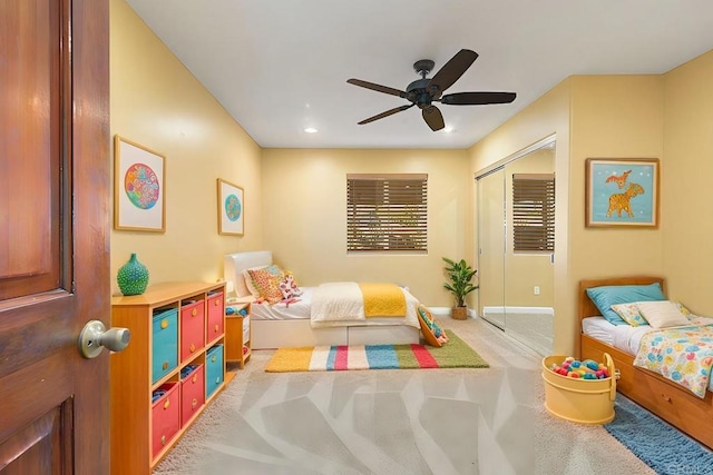 carpeted bedroom featuring ceiling fan and a closet