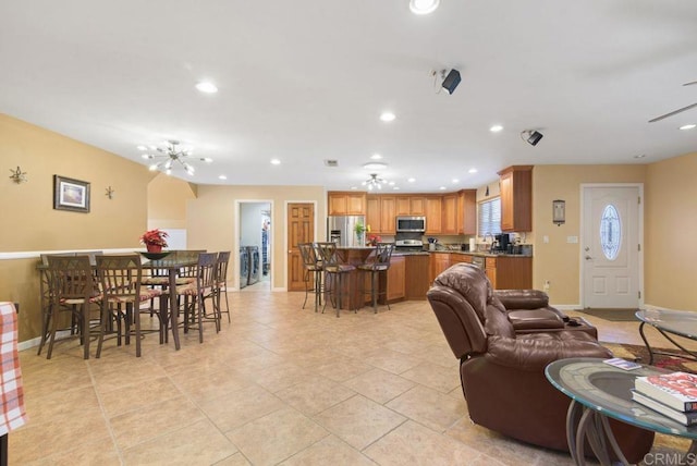 living room featuring light tile patterned flooring and an inviting chandelier