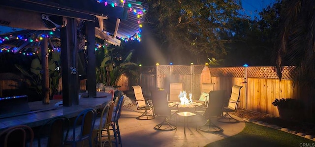 patio at night featuring a bar