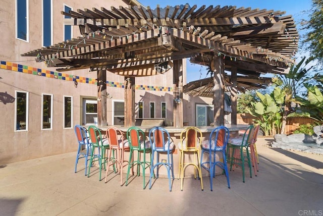 view of patio with a pergola and a bar