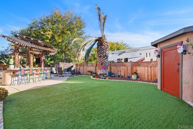 14429 Springvale St, Poway, CA 92064 - view of yard featuring a patio, a pergola, outdoor dry bar, an outdoor structure, and a fenced backyard
