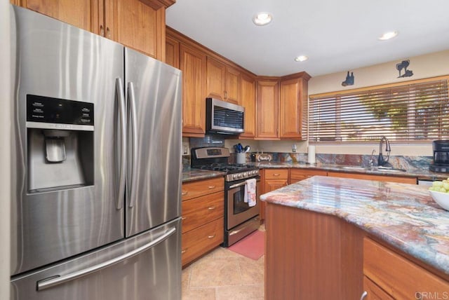 14429 Springvale St, Poway, CA 92064 - kitchen featuring recessed lighting, a sink, dark stone countertops, brown cabinets, and stainless steel appliances