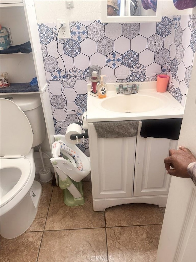 bathroom featuring tile patterned floors, decorative backsplash, vanity, and toilet