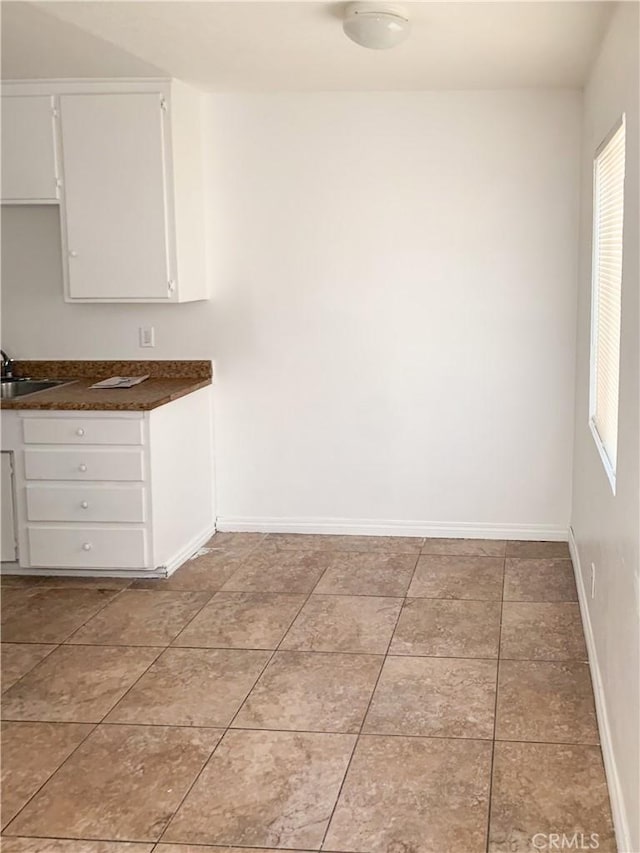 interior space with sink and light tile patterned flooring