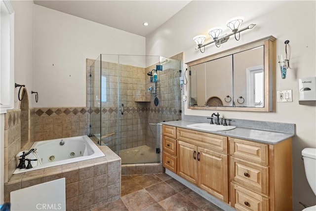 full bathroom featuring vanity, separate shower and tub, and toilet