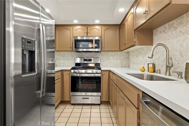 kitchen featuring light tile patterned flooring, appliances with stainless steel finishes, decorative backsplash, and sink