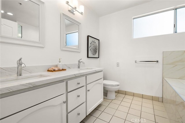 bathroom featuring tile patterned flooring, vanity, toilet, and plenty of natural light