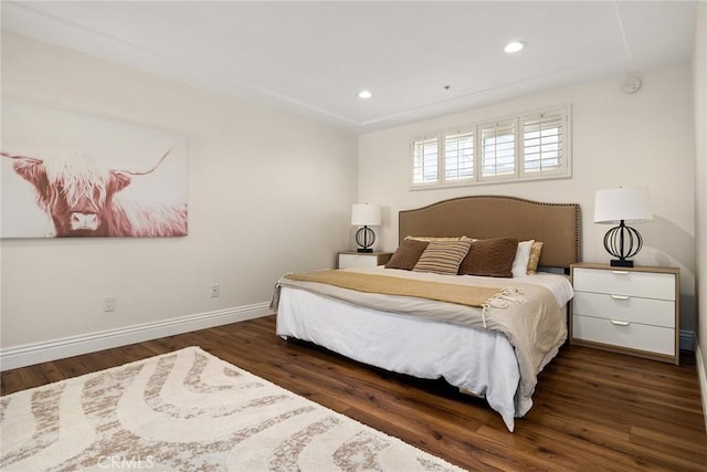 bedroom with dark hardwood / wood-style floors