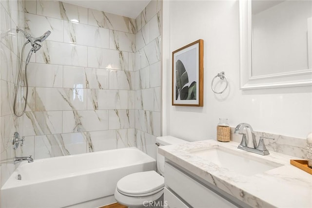 full bathroom featuring vanity, tiled shower / bath combo, and toilet