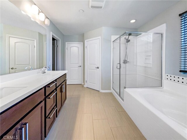 bathroom featuring tile patterned floors, vanity, and plus walk in shower