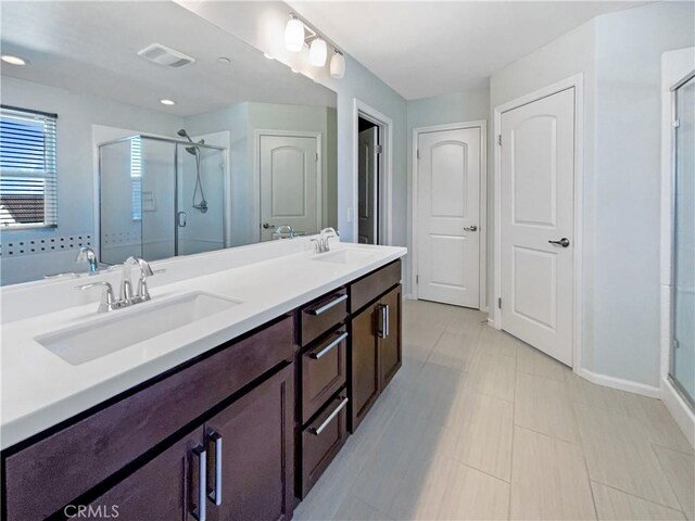 bathroom with vanity, tile patterned floors, and a shower with shower door