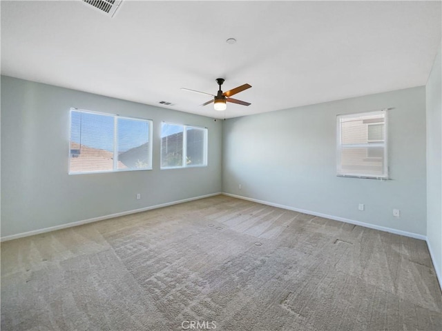 empty room with ceiling fan and light colored carpet