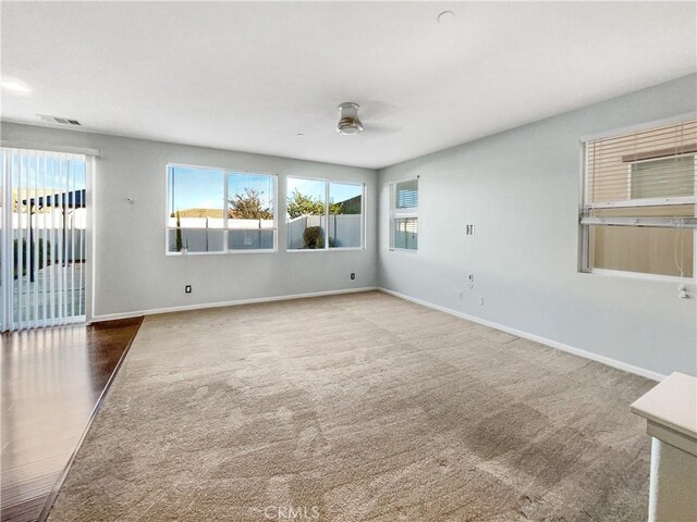 empty room with carpet flooring and ceiling fan