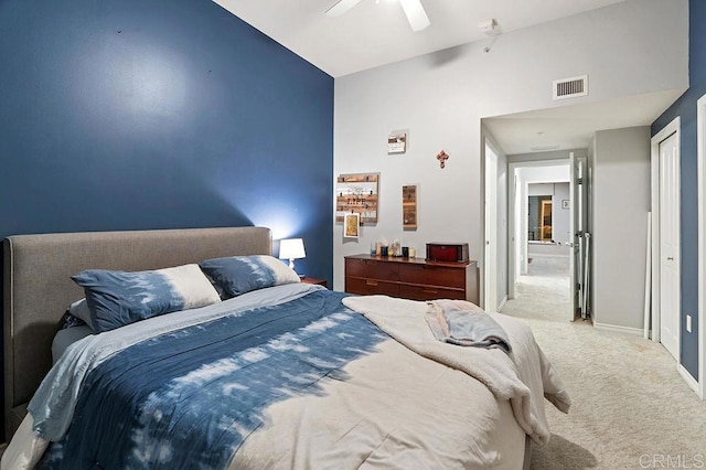 carpeted bedroom featuring ceiling fan, a closet, and lofted ceiling