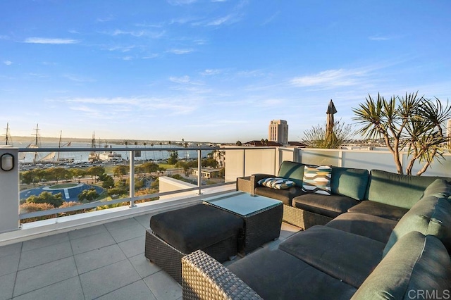 view of patio featuring a balcony, a water view, and an outdoor hangout area