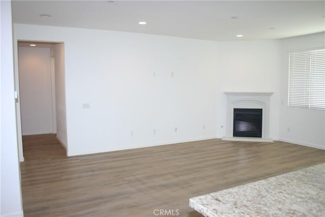 unfurnished living room with hardwood / wood-style floors