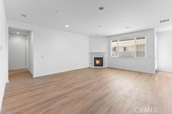 unfurnished living room with light wood-type flooring