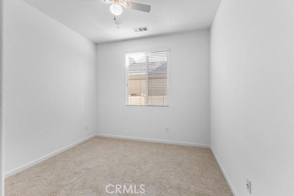 unfurnished room with light carpet and ceiling fan