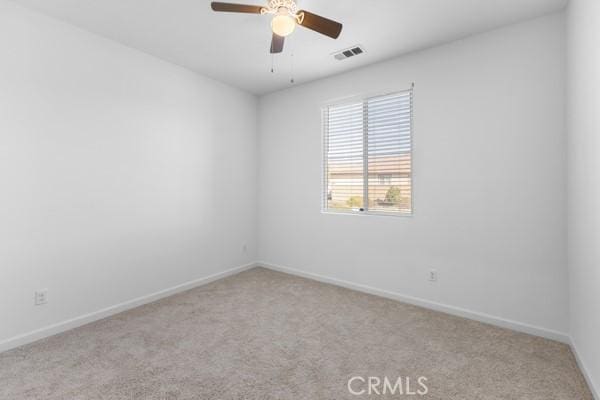 empty room with light colored carpet and ceiling fan