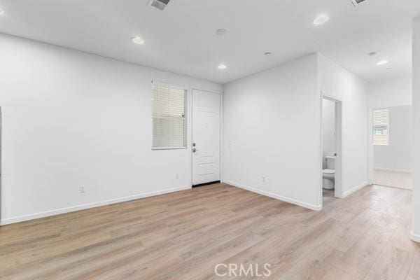 empty room with light hardwood / wood-style floors