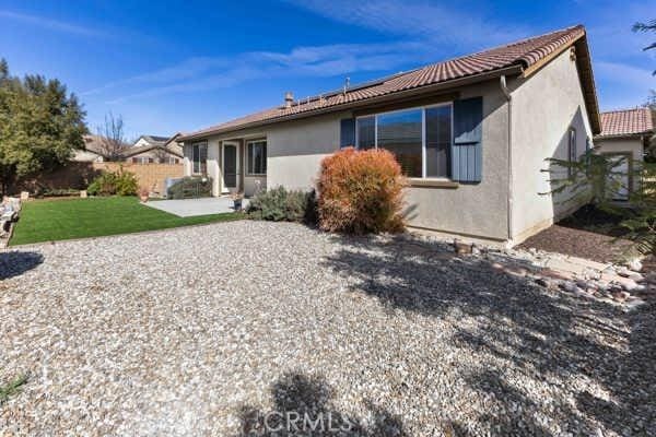 rear view of property with a yard and a patio area