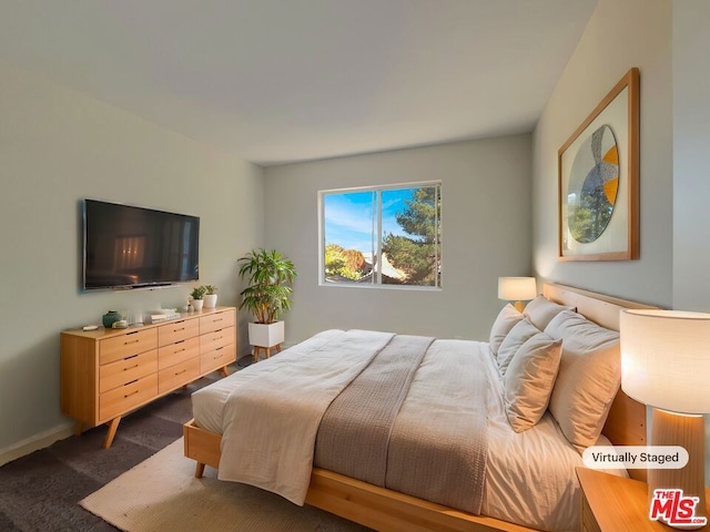 bedroom featuring dark colored carpet