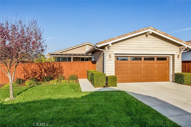 ranch-style home featuring a garage and a front yard