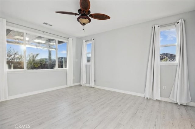 empty room featuring ceiling fan and light hardwood / wood-style floors