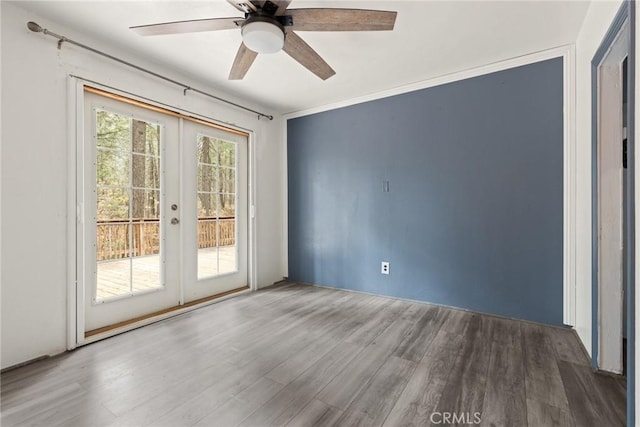 empty room featuring hardwood / wood-style flooring, ceiling fan, and french doors