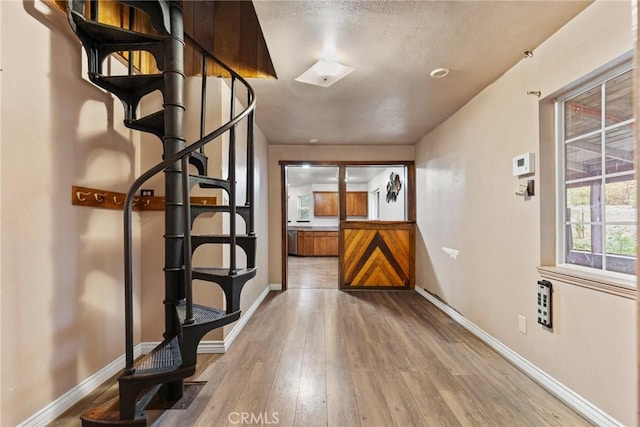 corridor with hardwood / wood-style flooring