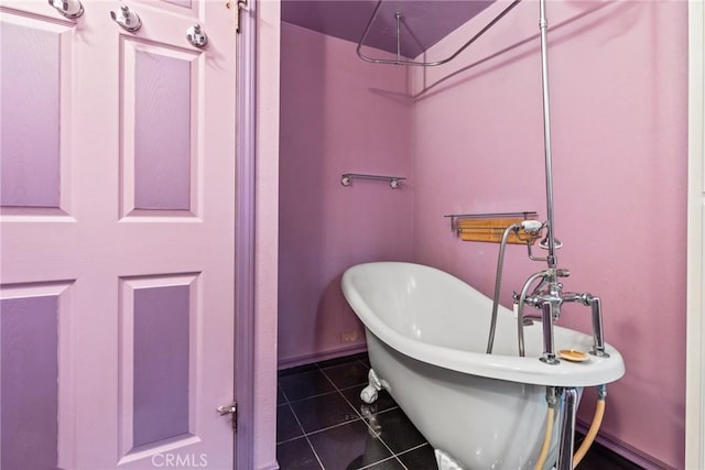 bathroom with a tub to relax in and tile patterned floors