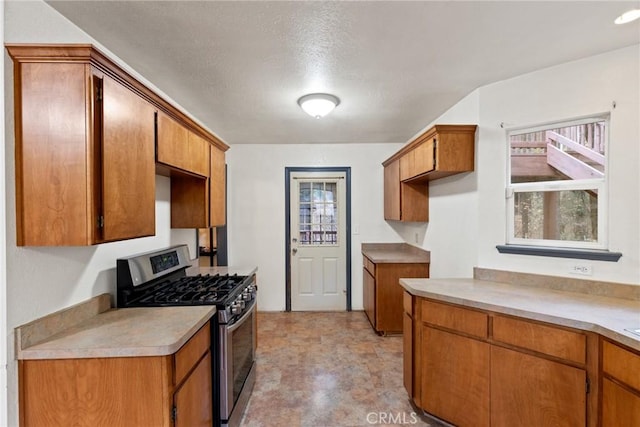 kitchen featuring stainless steel range with gas cooktop and a textured ceiling