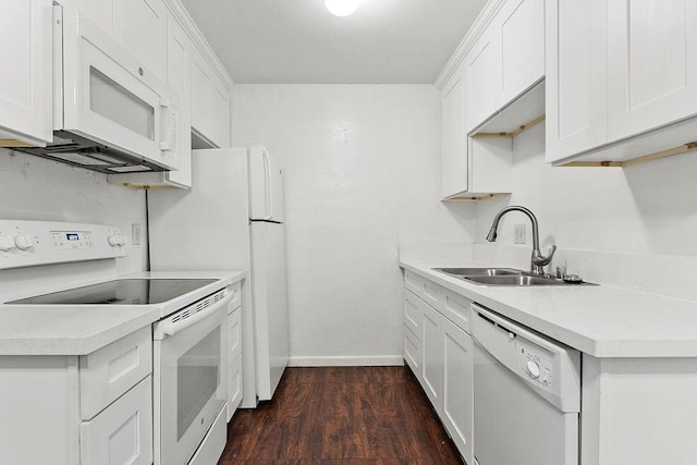 kitchen featuring white cabinetry, dark wood-type flooring, and white appliances