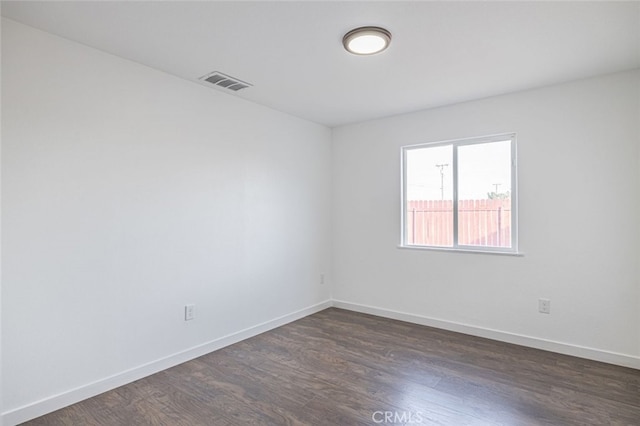 unfurnished room with dark hardwood / wood-style flooring