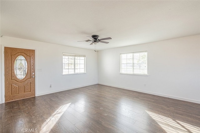 foyer with a textured ceiling, dark hardwood / wood-style flooring, and ceiling fan