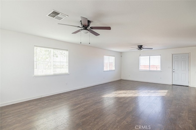 unfurnished room featuring ceiling fan, dark hardwood / wood-style flooring, and a textured ceiling