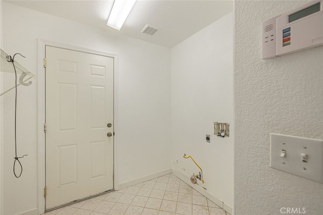 laundry area featuring washer hookup, gas dryer hookup, and light tile patterned floors