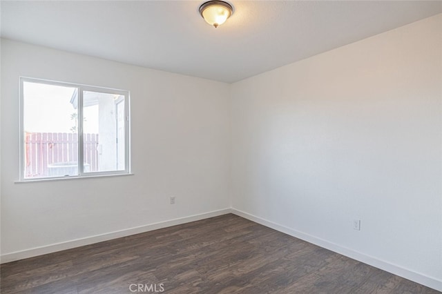 spare room featuring dark hardwood / wood-style flooring