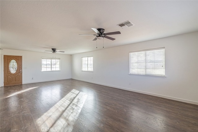 interior space featuring a textured ceiling, dark hardwood / wood-style floors, and ceiling fan