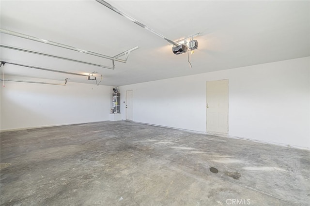 garage with secured water heater and a garage door opener