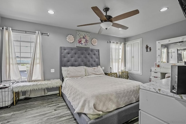 bedroom with ceiling fan and light wood-type flooring