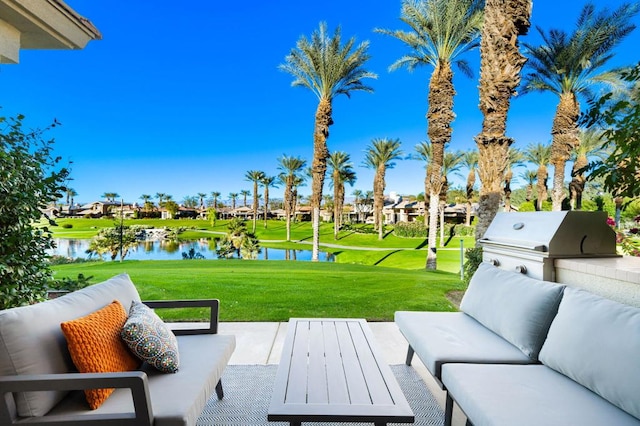 view of patio with a grill, area for grilling, and a water view