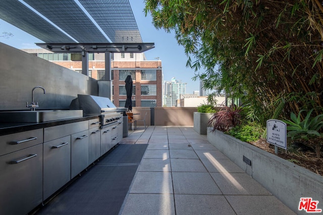 view of patio with sink, area for grilling, and exterior kitchen