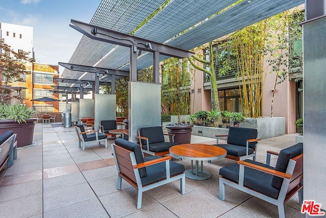 view of patio featuring outdoor lounge area and a pergola