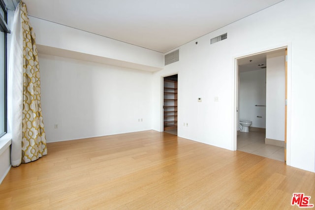 spare room with light hardwood / wood-style flooring