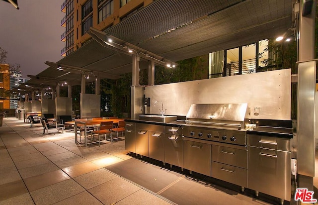 view of patio / terrace with area for grilling, sink, and exterior kitchen