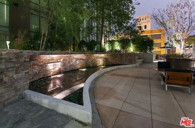 view of patio terrace at dusk