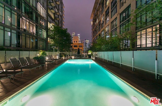 view of pool at dusk