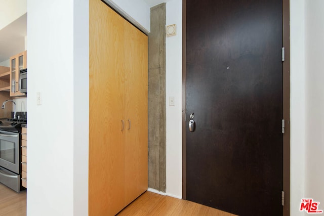 corridor with light hardwood / wood-style flooring