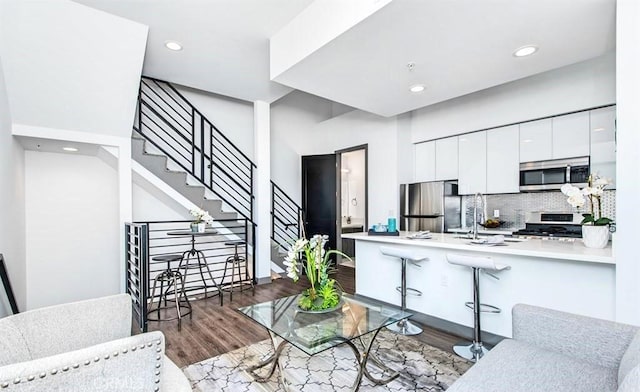 644 N Normandie Ave, Los Angeles, CA 90004 - living room with wood finished floors, recessed lighting, and stairway
